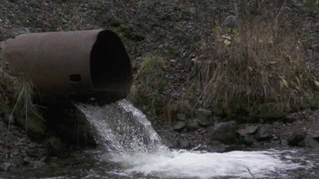water flows from the drainage pipe. Super slow motion 1000 fps.