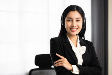 Call centre female operator. Smiling asian business woman receptionist wearing headphone video conference calling talk by webcam in online chat customer support service.