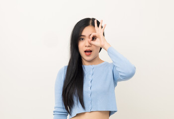 Portrait of Young beautiful Asian woman standing and smiling isolated on white background showing ok sign. Attractive female wearing blue shirt feeling surprised and happy.
