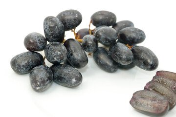 Bunch of organic black grapes isolated on white background