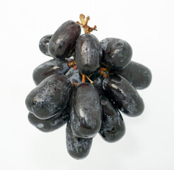 Black grapes with drop of water isolated on white background look like tasty