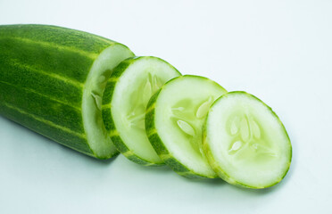 Close-up fresh green cucumbers slices isolated on white background
