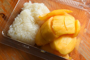 Ripe mango with sticky rice in a plastic box
