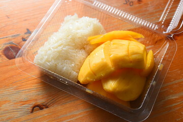 Ripe mango with sticky rice in a plastic box
