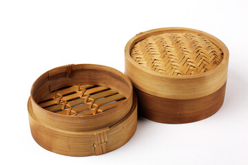 Traditional bamboo basket oriental dimsum steamer with lid and two base, on white background photo.