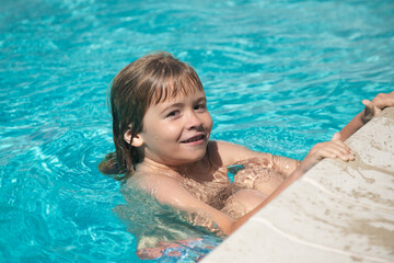 Child boy swim in swimming pool. Kids summer vacation concept.