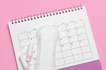 Menstruation calendar. Calendar with pads and tampons on a pink background