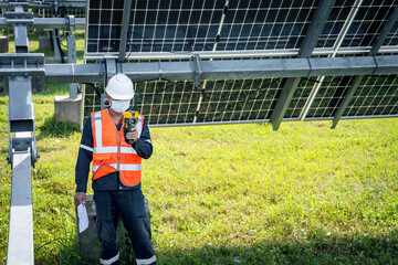 The technician takes the Thermoscan(thermal image camera) scan to the solar panel to check the hot spots in the cell, Concept to use technology to check the damage in the Solar plant
