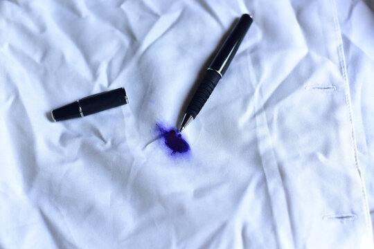 Dirty pen ink stain on fabric from accident in daily life. Concept of cleaning stains on clothes or cleaning the house. Selected  stains on white shirts