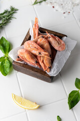 Thawed peeled shrimp, seafood, delicacy. on a white background, in a dish. beautiful product presentation