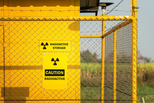 A radioactive source storage bunker with "Danger, Radioactive" symbol on wire fence of the restricted storage area.