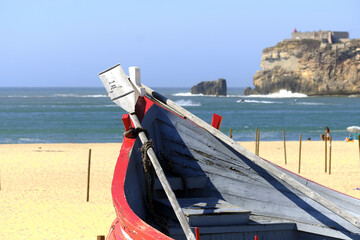 old colorful traditional fishing boats on Nazare Beach, Portugal