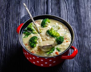 Broccoli cheese soup in a pot, top view