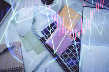 Multi exposure of financial chart drawing over table background with computer. Concept of research and analysis. Top view.
