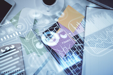 Technology hologram drawing over computer on the desktop background. Top view. Double exposure....