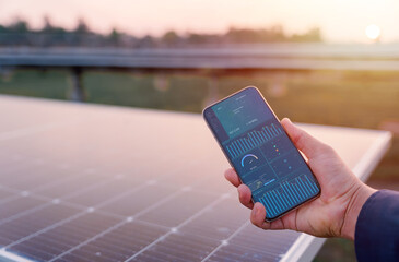Man hand holding the telephone for monitoring performance in solar power plant(solar cell)....