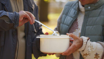 Charity organization gives away food in white cooking pods to help people in need. High quality photo