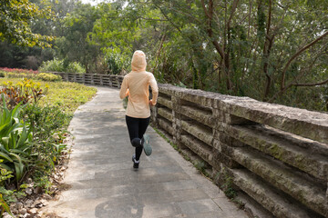 Asian woman jogging in park