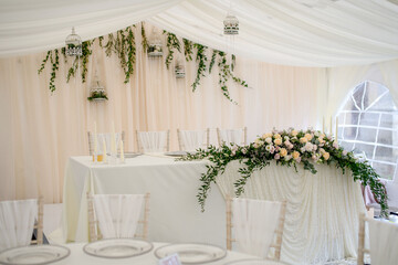 The interior is white with elements of flowers and greenery on the tables with dishes