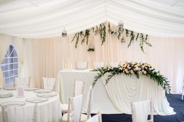 The interior is white with elements of flowers and greenery on the tables with dishes