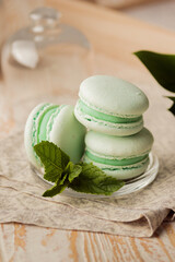 Fototapeta na wymiar Delicious green macaroons with mint 