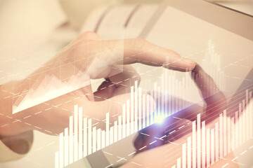 Multi exposure of man's hands holding and using a phone and financial chart drawing. Market analysis concept.