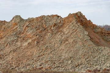 Ground development. A pile of sand on a construction site. Earthworks for the construction of foundations and underground communications.