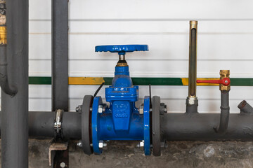 Industrial valve on a gas or heating pipe. Installation of a heating unit in a production room....