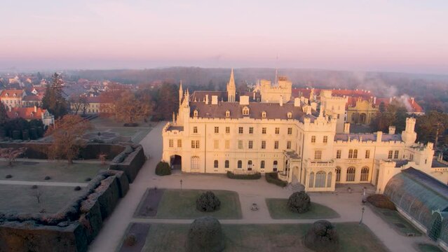 Aerial View Of Lednice Castle, Moravia, Czechia. Famous Tourist Spot. Fairytale Castle In A Baroque Garden, Lit By The Morning Sun. Unesco Cultural Heritage. Winter Season, Moravia, Czech Republic.