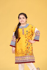 Pakistani child girl is wearing easter or western dress. Kids girl dress.