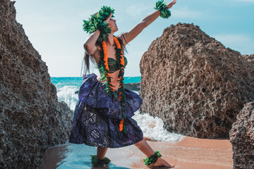 Gorgeous woman dressed in traditional Hawaiian dance attire enjoying views of a spectacular...