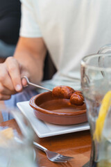person with chorizo tapas