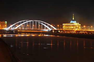 Fototapeta na wymiar Nur-Sultan / Kazakhstan - 11.07.2011 : Night lighting of streets, bridges and the presidential administration in the Central part of the capital.