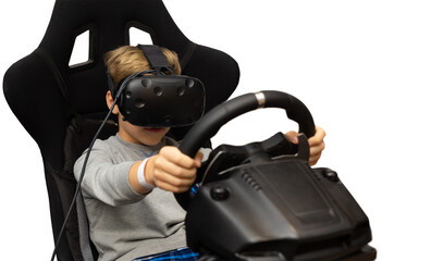 The boy plays on the racing simulator in glasses of a virtual reality isolated on white background.