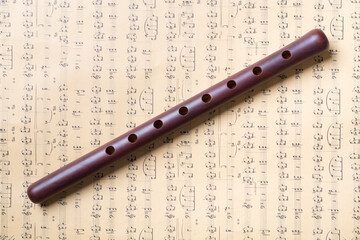 Armenian national musical instrument duduk on notes background. Top view