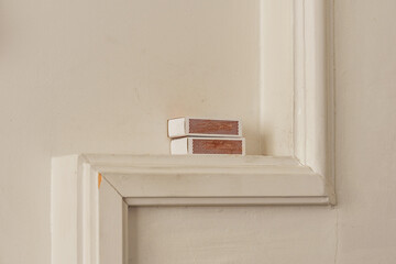 Fototapeta premium matchboxes on a mantelpiece by the stove