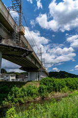 railway bridge crosses a stream in countryside, JAPAN.