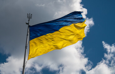 Biggest in Ukraine ukrainian national flag in Kiev on blue sky background, stop russian invasion, freedom and independence in Europe
