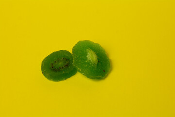 dried kiwi on a yellow background