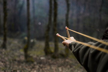 A rock is pulled back in an sling shot pointed 