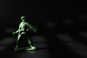 Obraz na płótnie Canvas image of toy soldiers over dark background