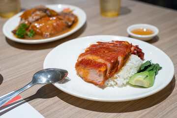 Barbecue pork combination. char siew and roasted pork with rice on wooden Table. Hong kong cuisine,...