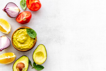 Homemade guacamole avocado dip with tomatoes and lime