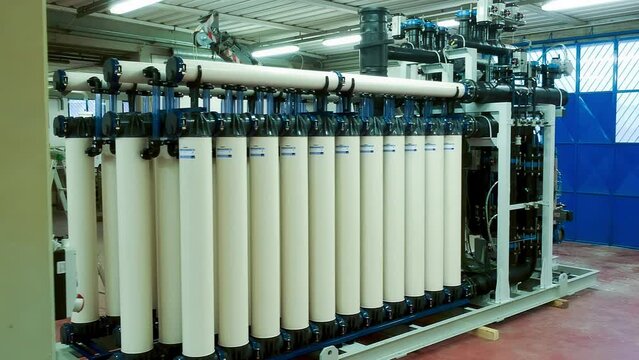 Slow motion view of a reverse osmosis system for water drinking plant. Water purification system, industrial environment from drone