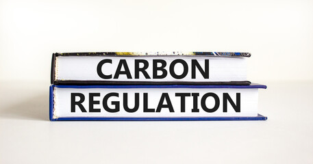 Carbon regulation symbol. Concept words Carbon regulation on books on a beautiful white table white background. Business and carbon regulation concept, copy space.