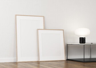 3d illustration on white wall. Two empty canvases, profile view decorated with table and lighted table lamp
