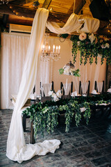 Table setting at a luxury wedding and beautiful flowers on the table.