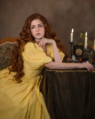 Red-haired girl in a yellow retro dress at the table