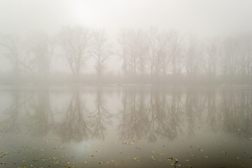 Fototapeta na wymiar Novi Sad, Serbia-January 12. 2013: Panorama of the pond covered with thick fog near the city of Novi Sad, Serbia.