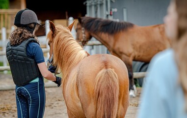 Dziewczynka odprowadza konia po zajęciach do stadniny